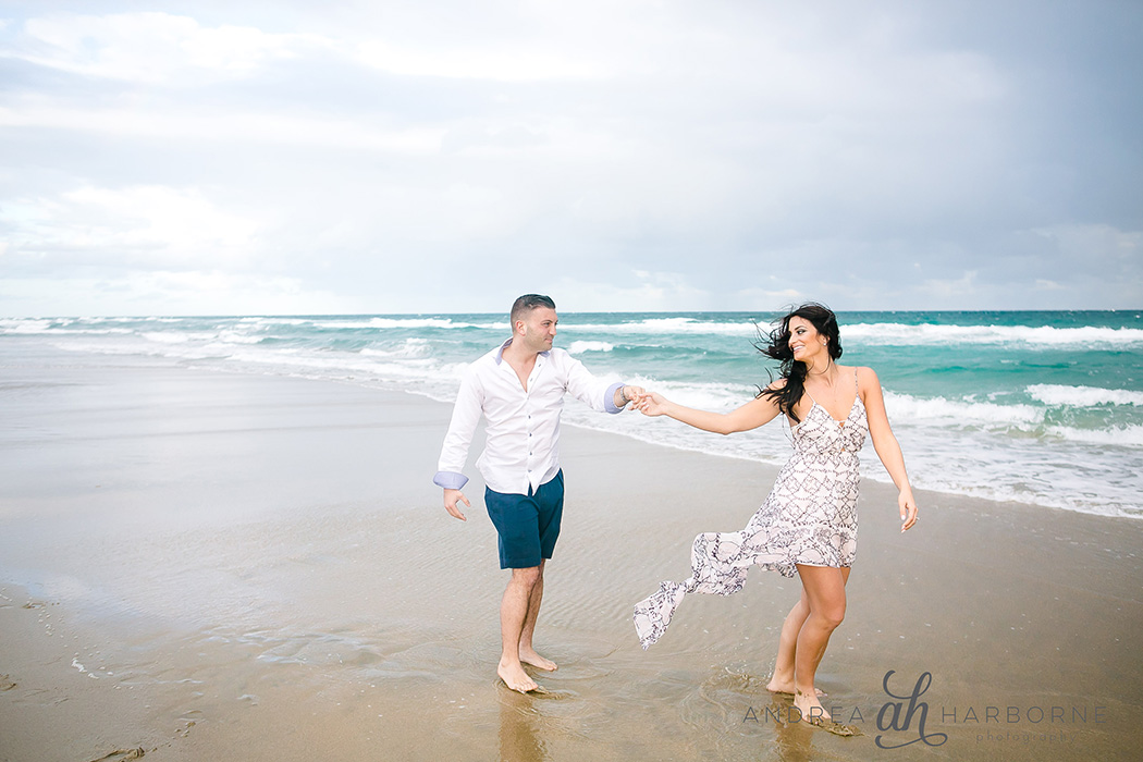couple hold hands during an engagement beach photography session | fort lauderdale engagement photographer