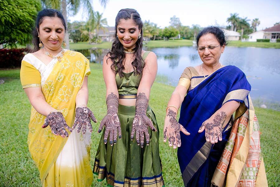 bride and her family posing during henna ceremony