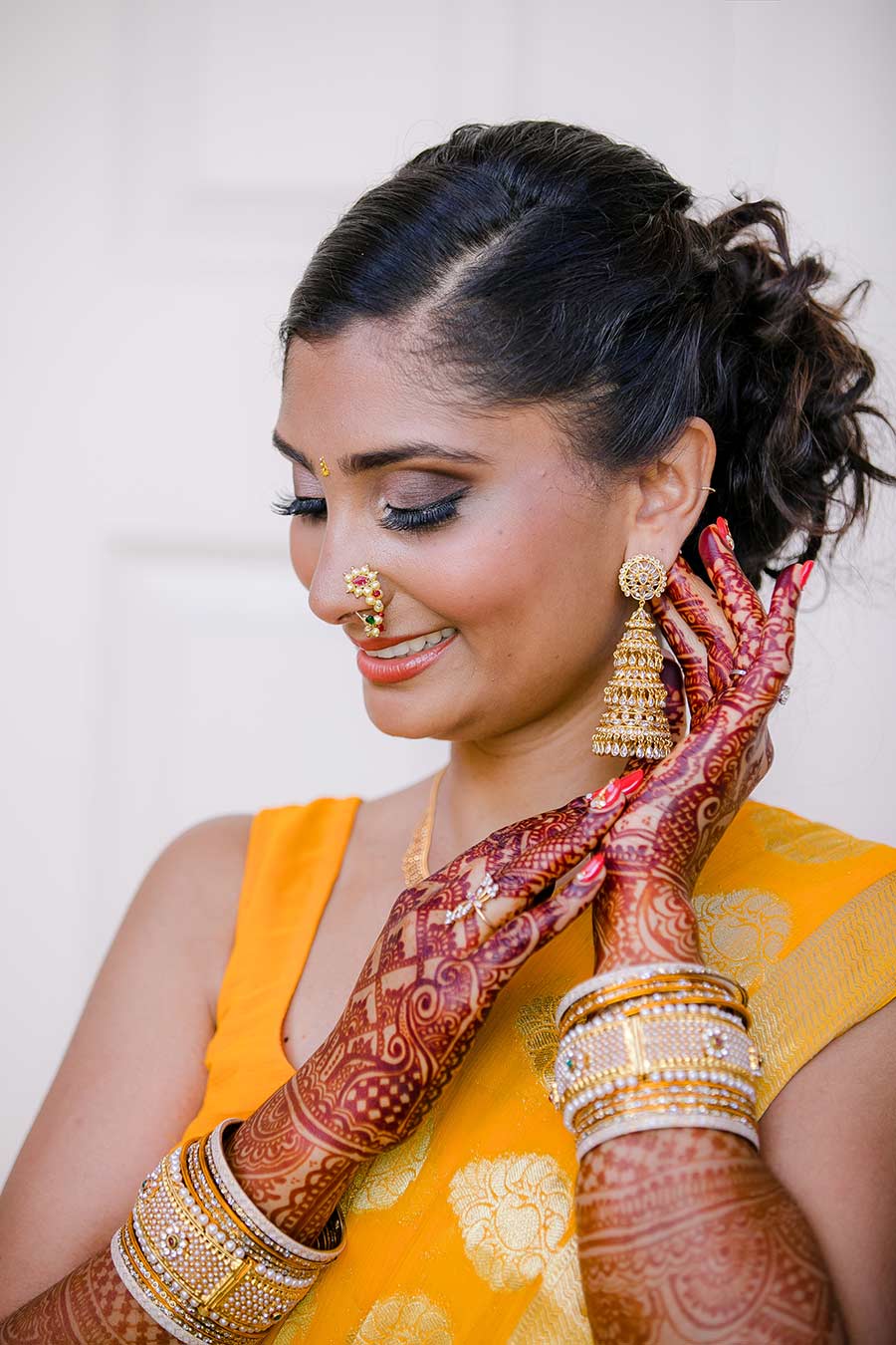indian bride pose wearing gold sari