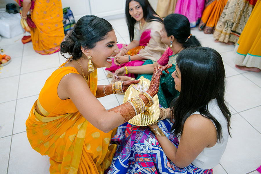 bride blesses family with tumeric during indian wedding
