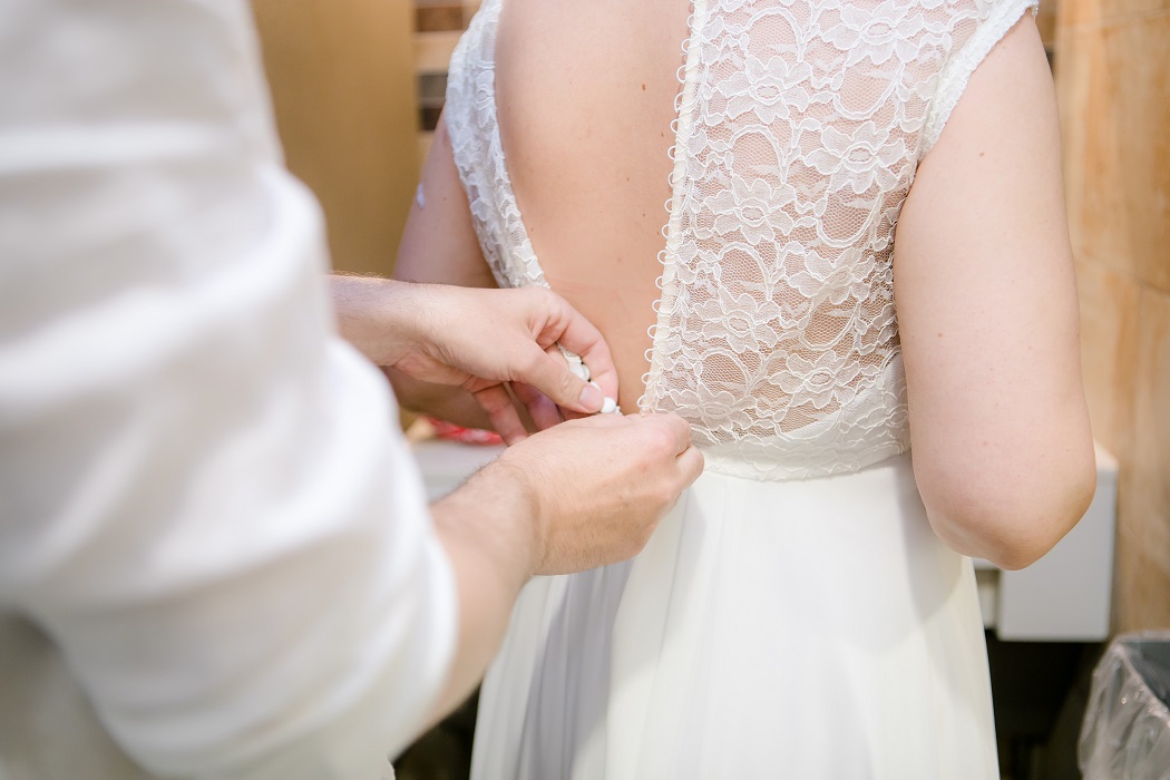 brides fiance helps her get dressed brides fiance helps her get dressed
