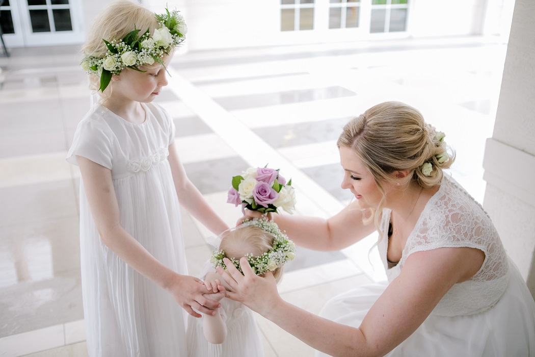 bride and flower girls prepare for ceremony | white and purple rose bouquet with babies breath flower crown bride and flower girls prepare for ceremony