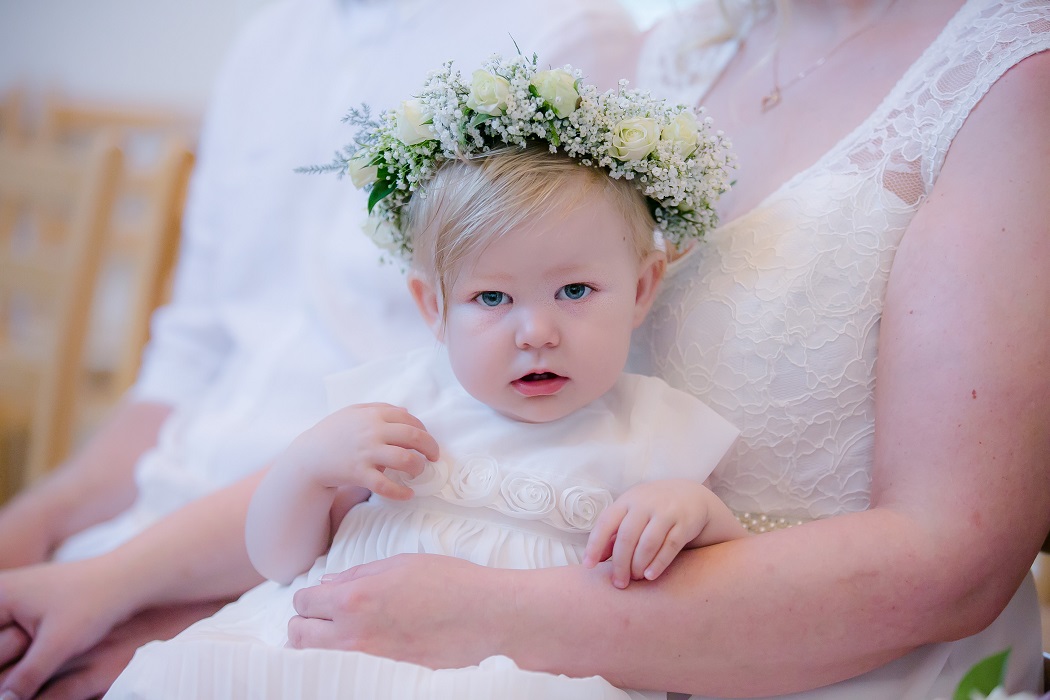 baby flower girls wears white roses and babies breath flower crown baby flower girl