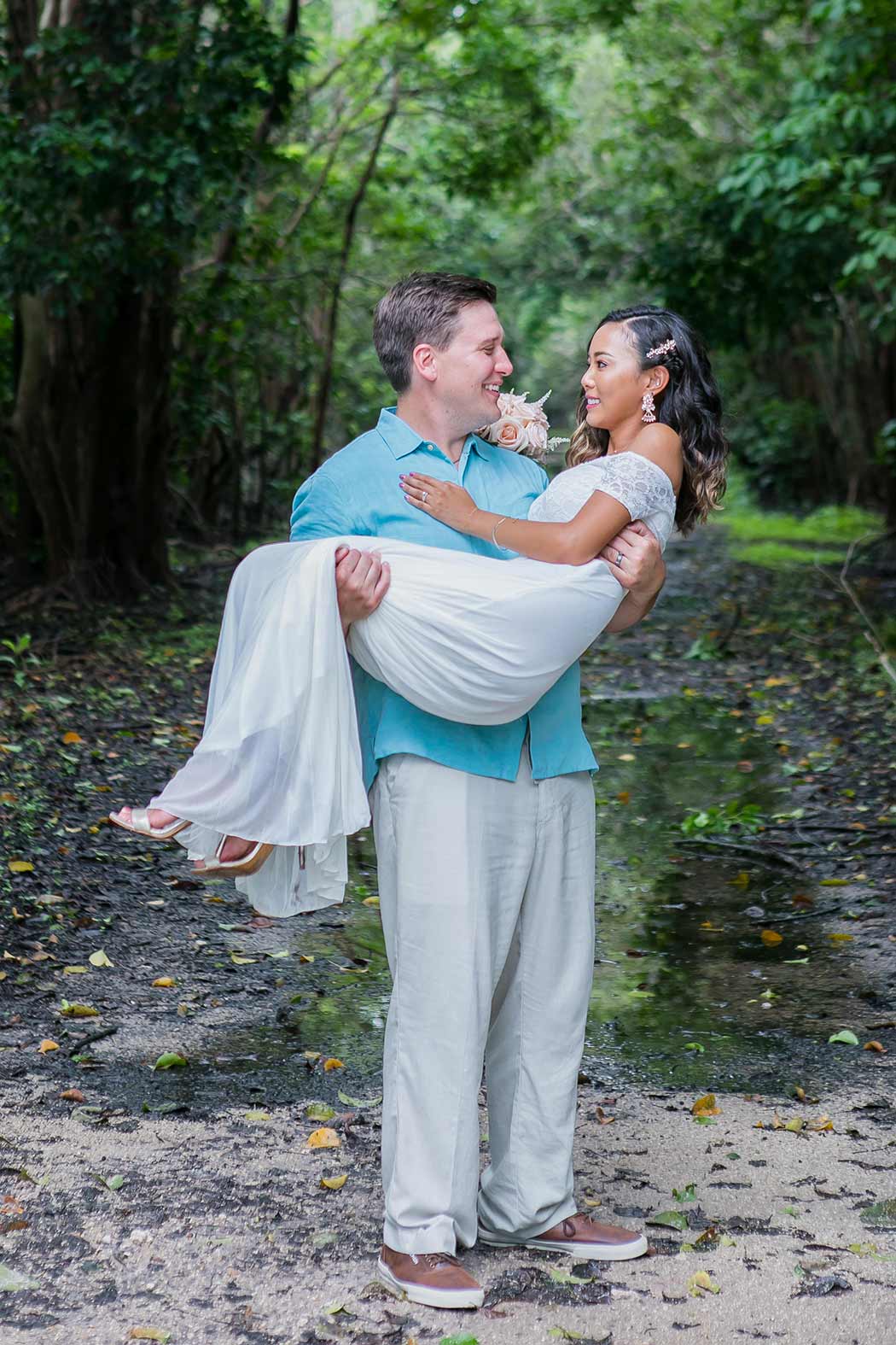 groom carries the bride