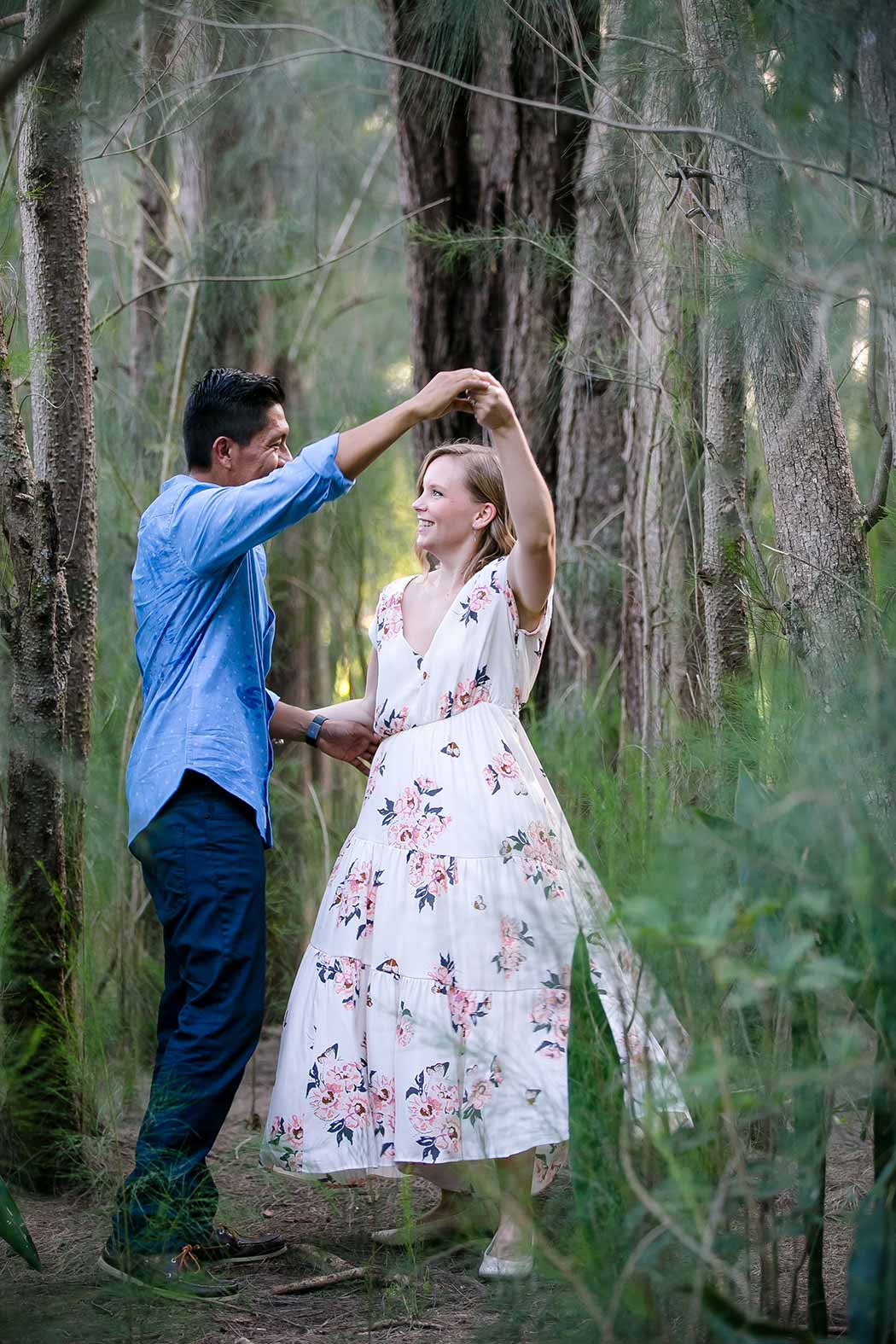couple dances during their engagement photoshoot in plantation heritage park