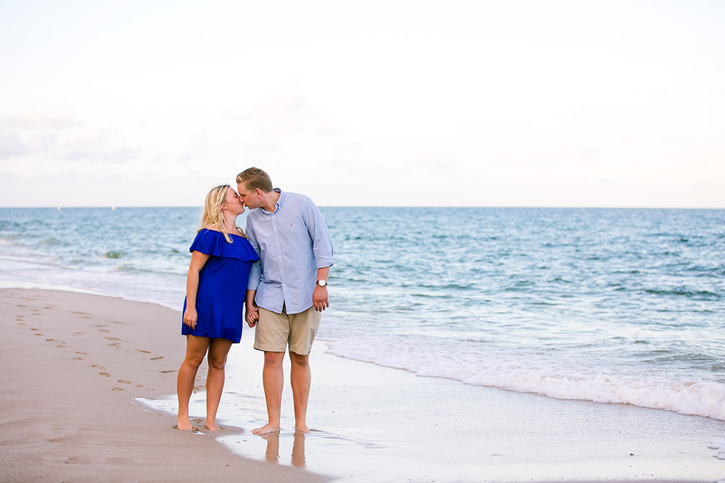 couple kiss on fort lauderdale beach after recently getting engaged
