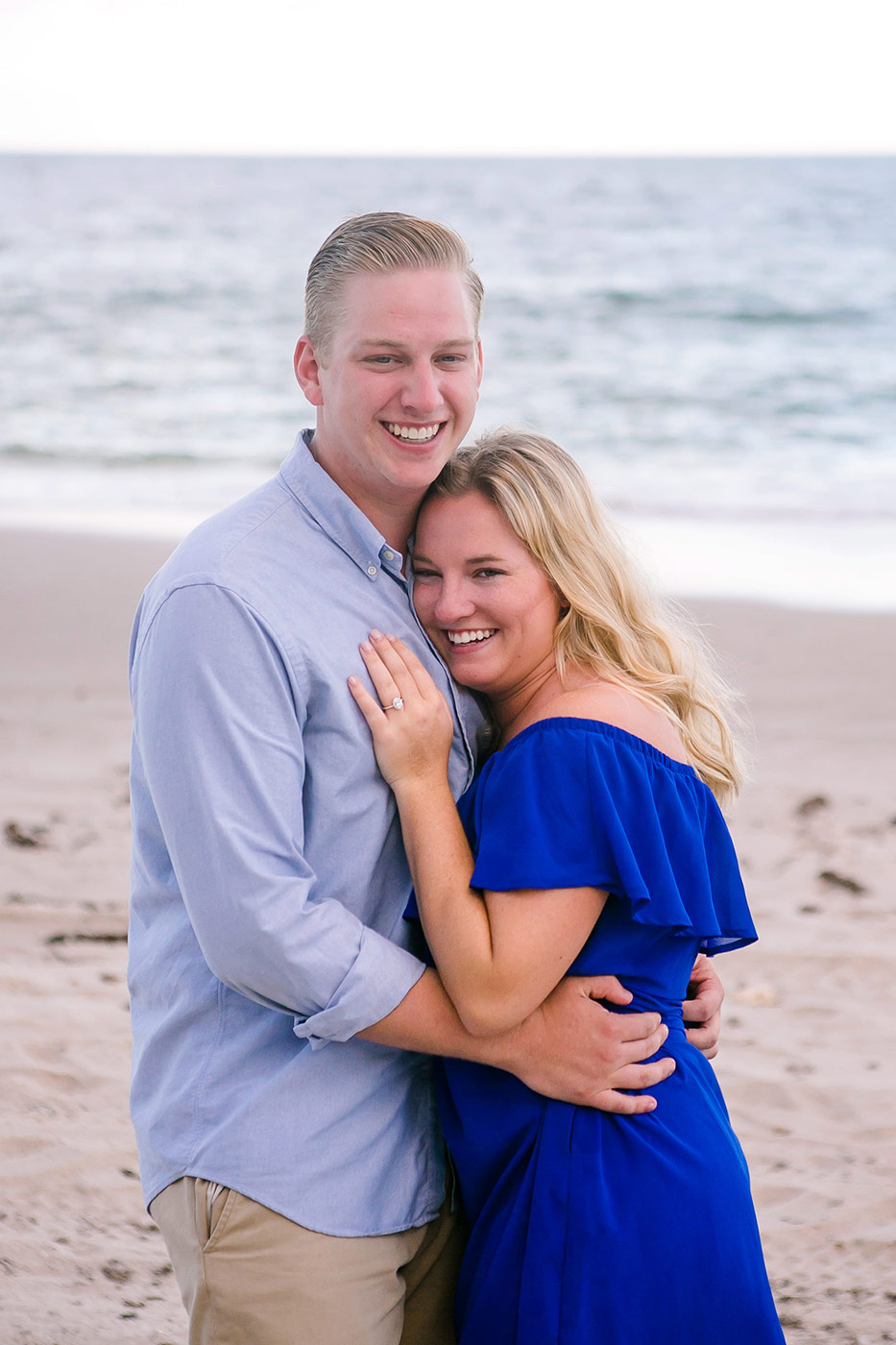 couple hug after he proposes on the beach in fort lauderdale