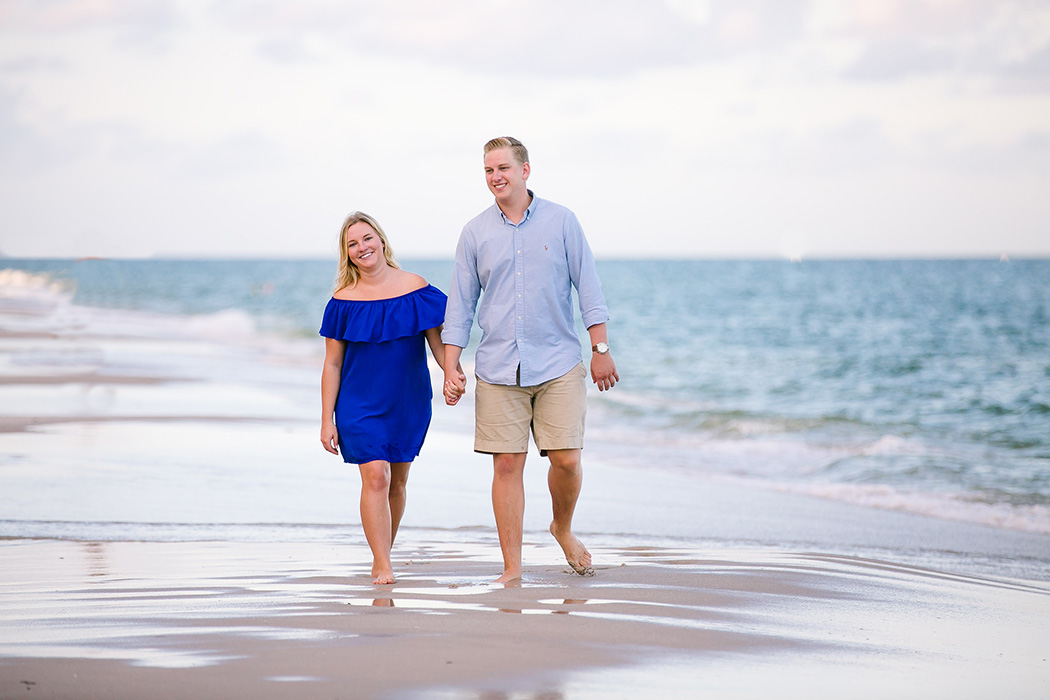 recently engaged couple walking on fort lauderdale beach