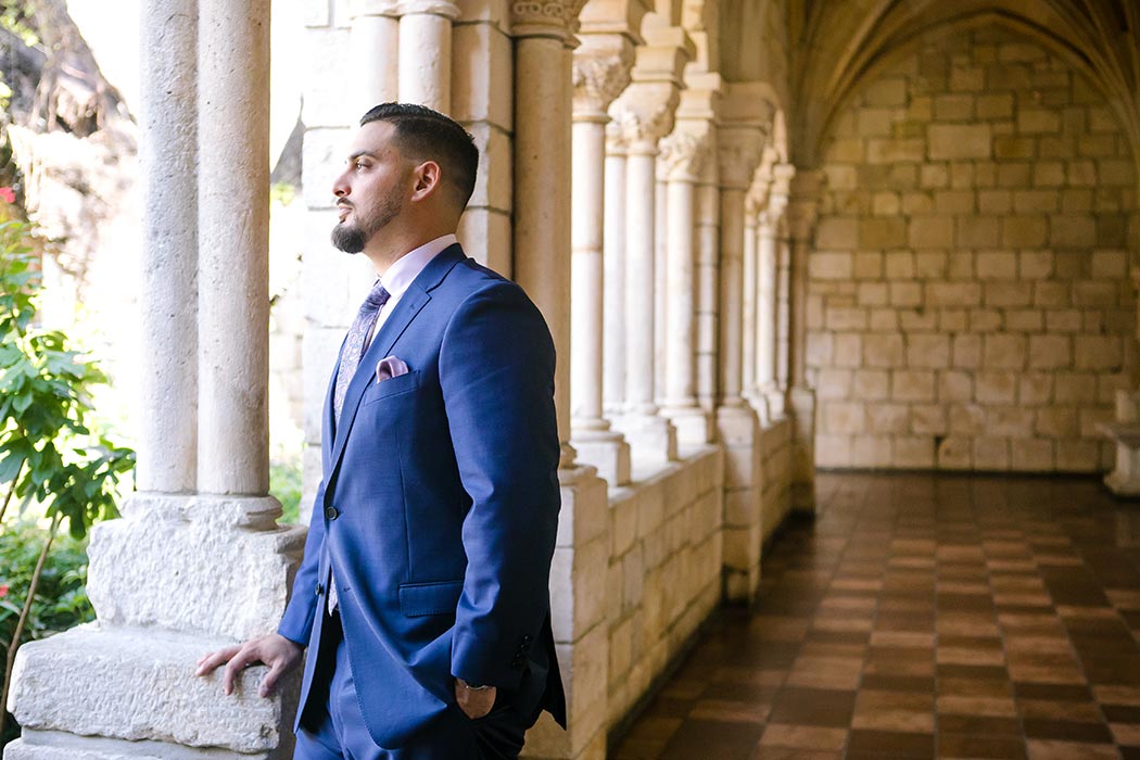groom poses for portrait pictures at the ancient spanish monastery | andrea harborne photography