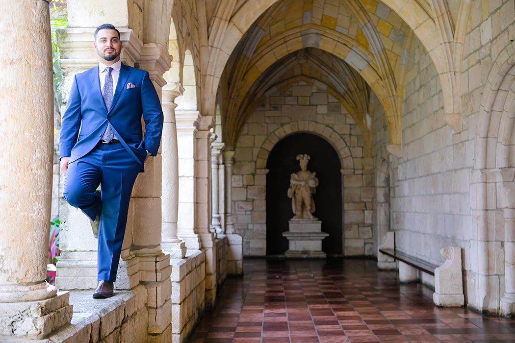 groom poses for portrait at ancient spanish monastery | andrea harborne photography