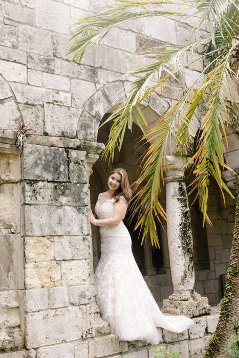 bride in lace wedding dress stands in the ancient spanish monastery, miami