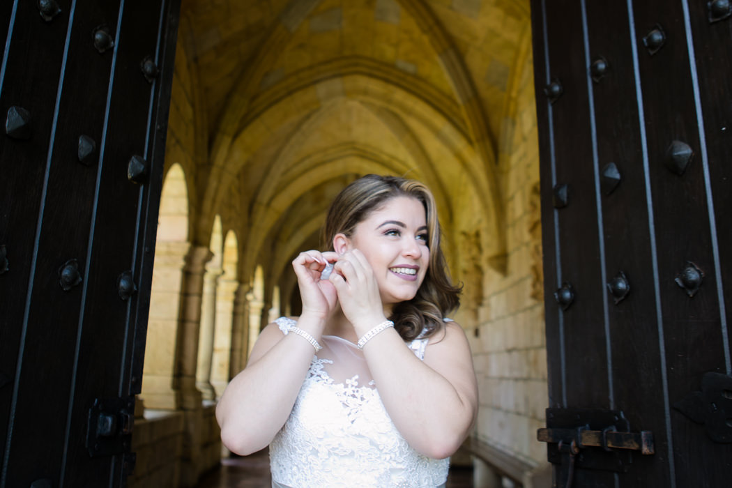 bride puts on her earrings before the ceremony | ancient spanish monastery | andrea harborne photography