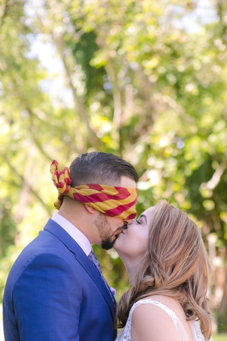 bride kisses groom during unique first look | andrea harborne photography | ancient spanish monastery, miami