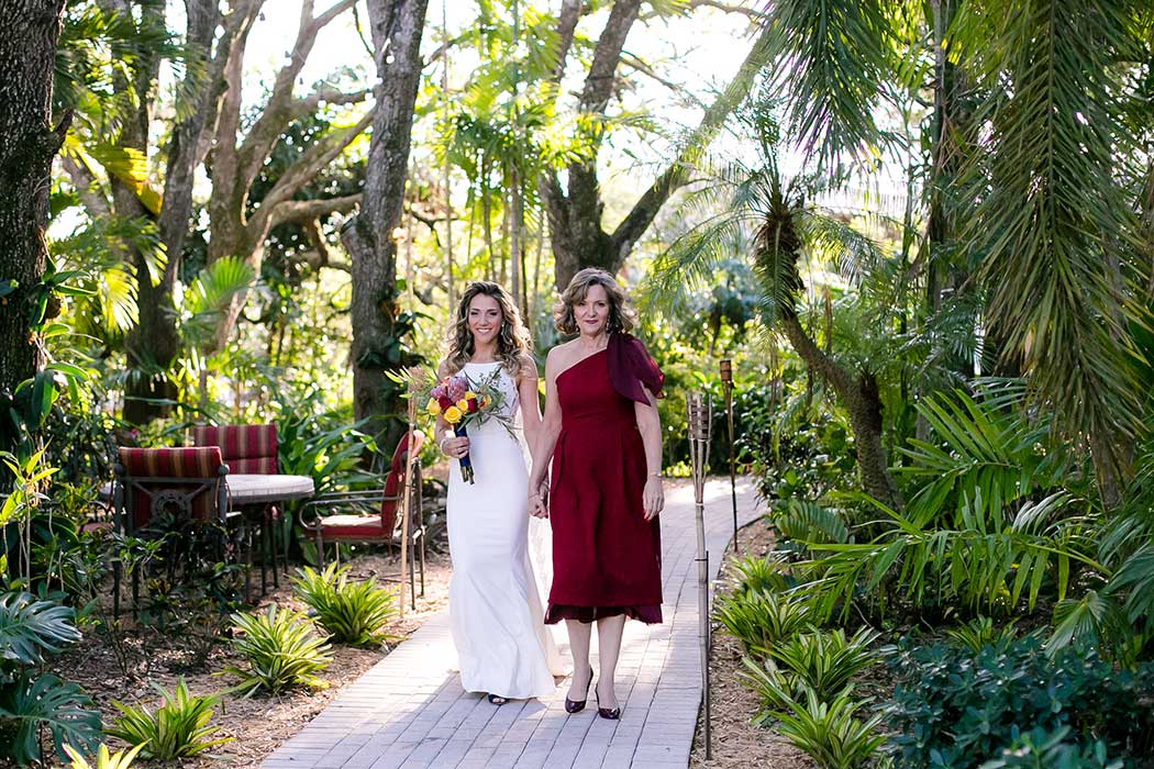 bride walks down the aisle with her mom | living sculpture sanctuary davie