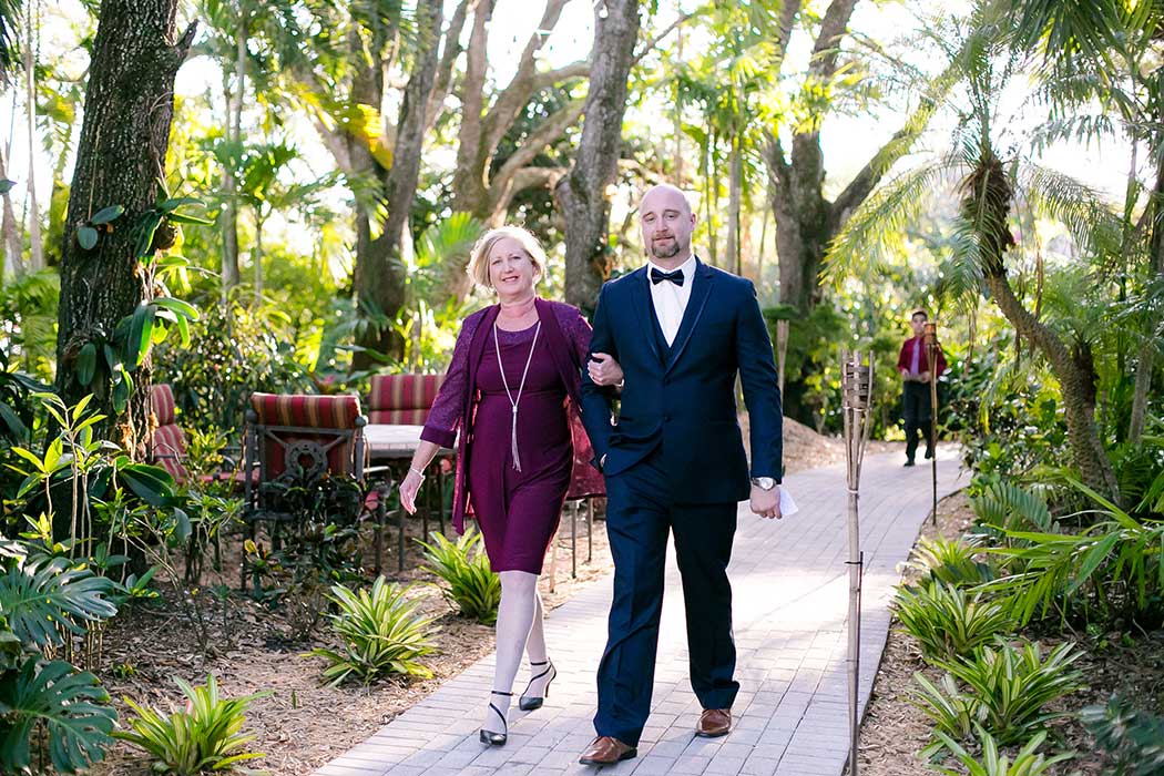 groom walks down aisle with his mom | living sculpture sanctuary davie