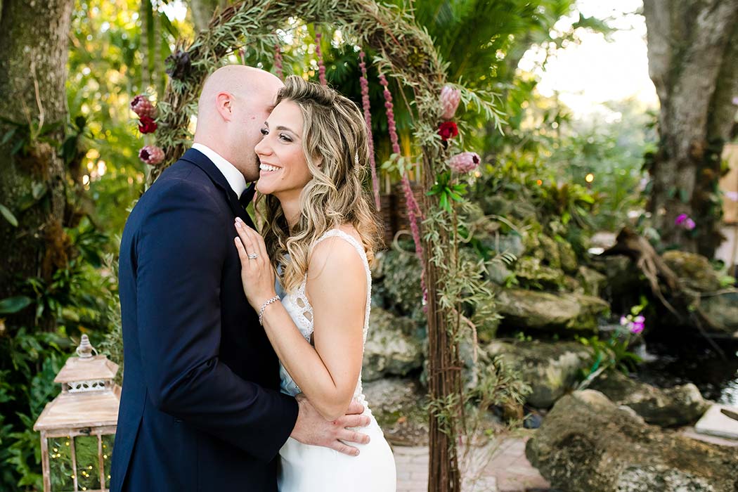 bride and groom with floral wedding arch | living sculpture sanctuary davie
