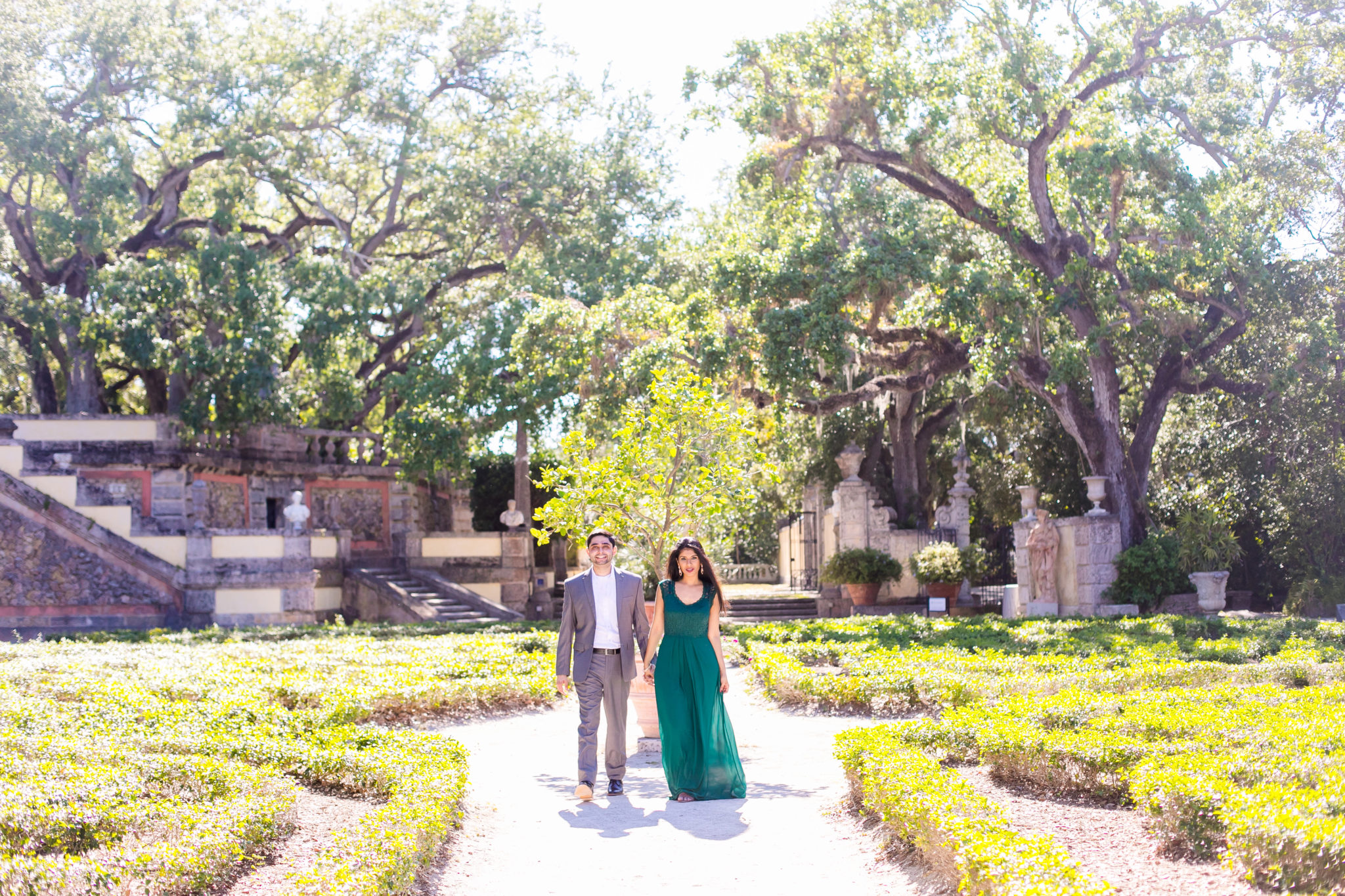couple walking in vizcaya museum, miami for their modern indian engagement photoshoot