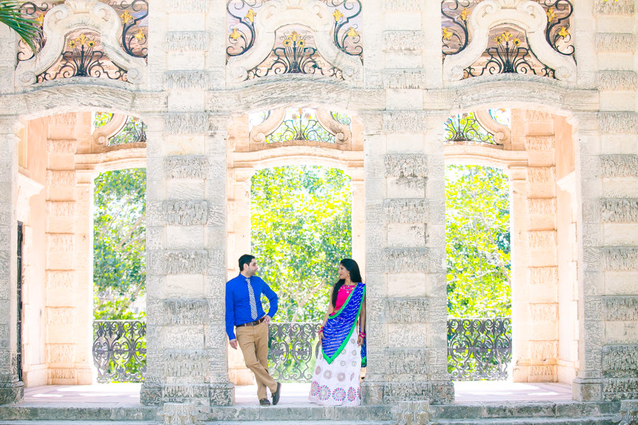 couple pose in traditional indian sari during engagement photoshoot at vizcaya