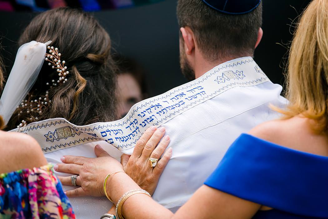 jewish bride and groom with tallit around their shoulders at east hotel, miami