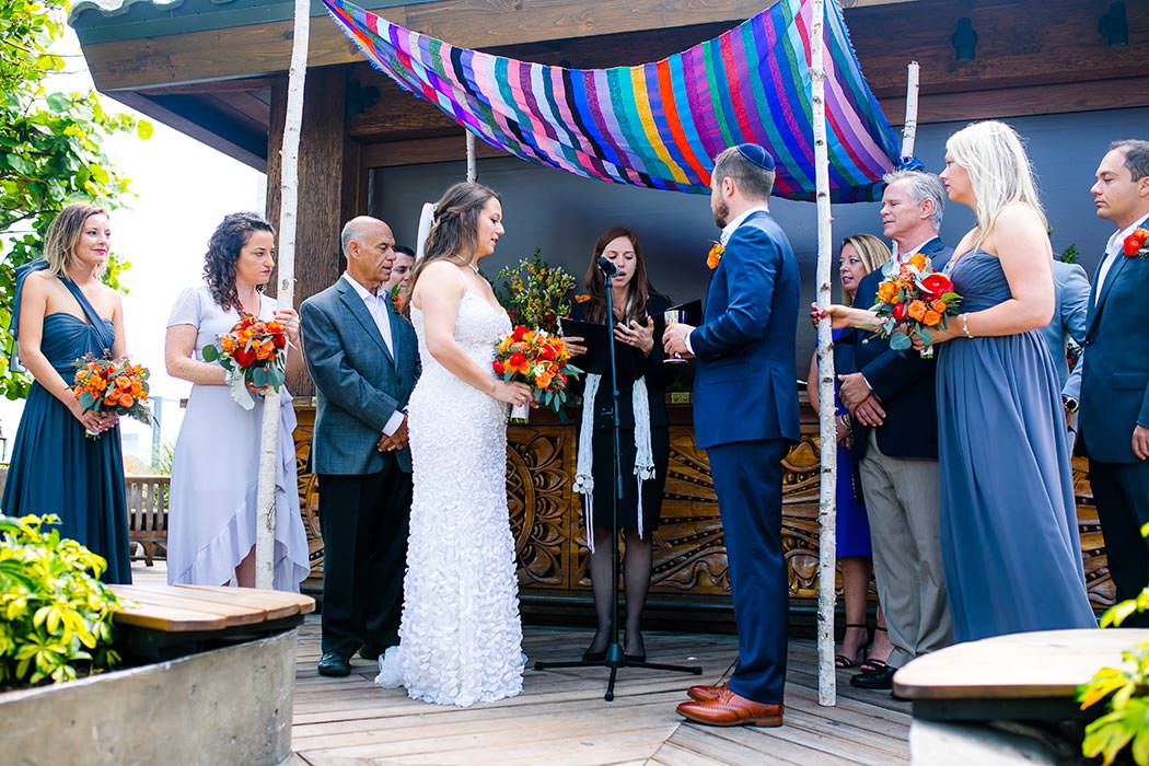 modern jewish wedding under colorful handmade chuppah at east hotel miami