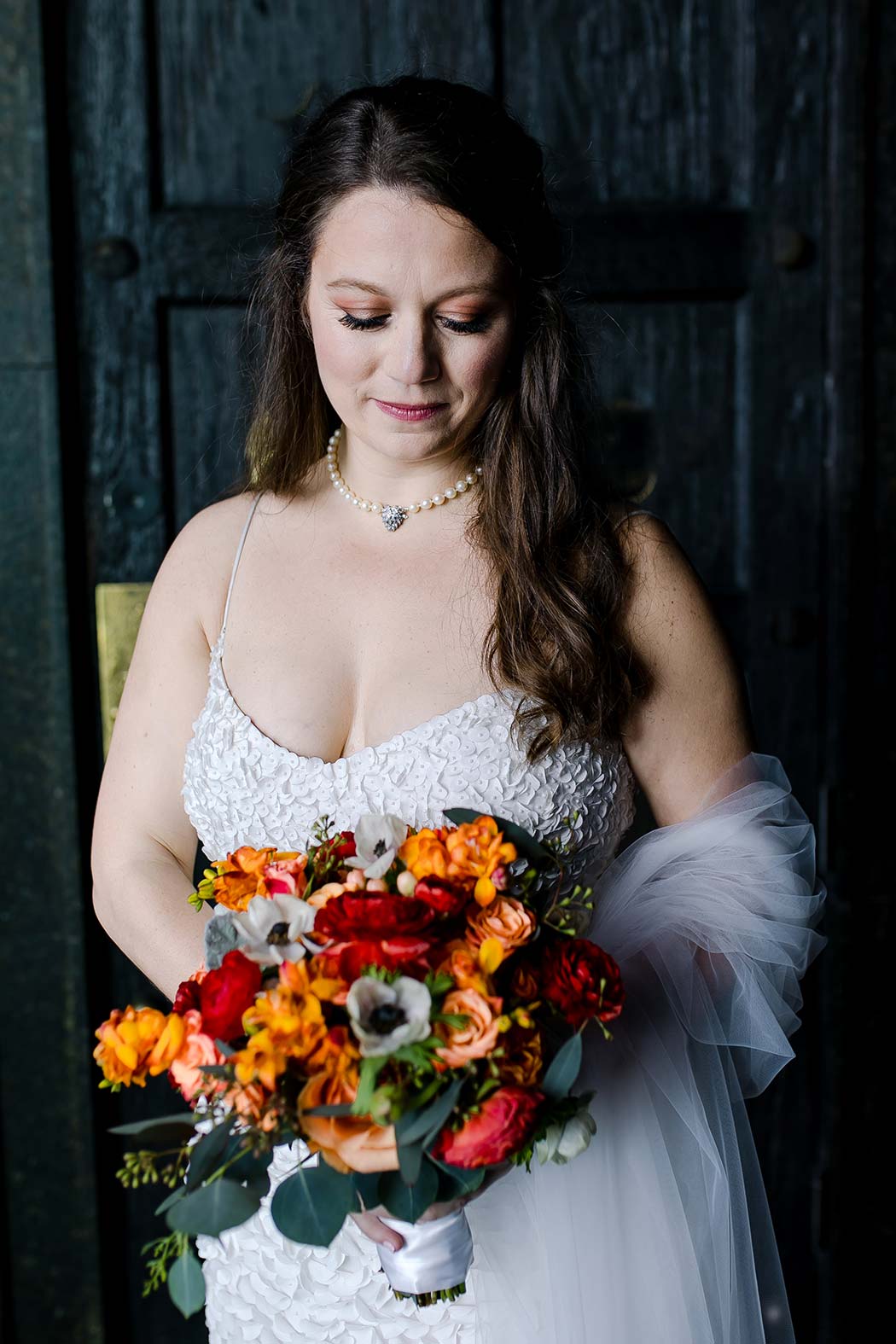 bridal portrait at east hotel miami with red and orange wedding bouquet