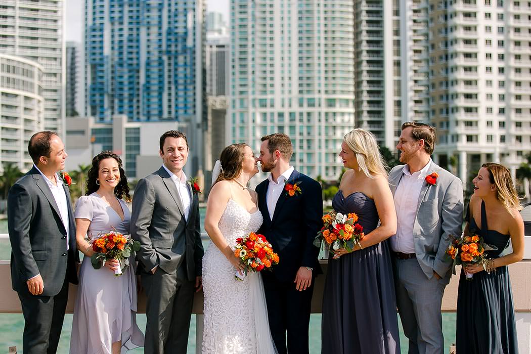 bride, groom and bridal party with miami skyline in the background | unique bridal party photograph in miami