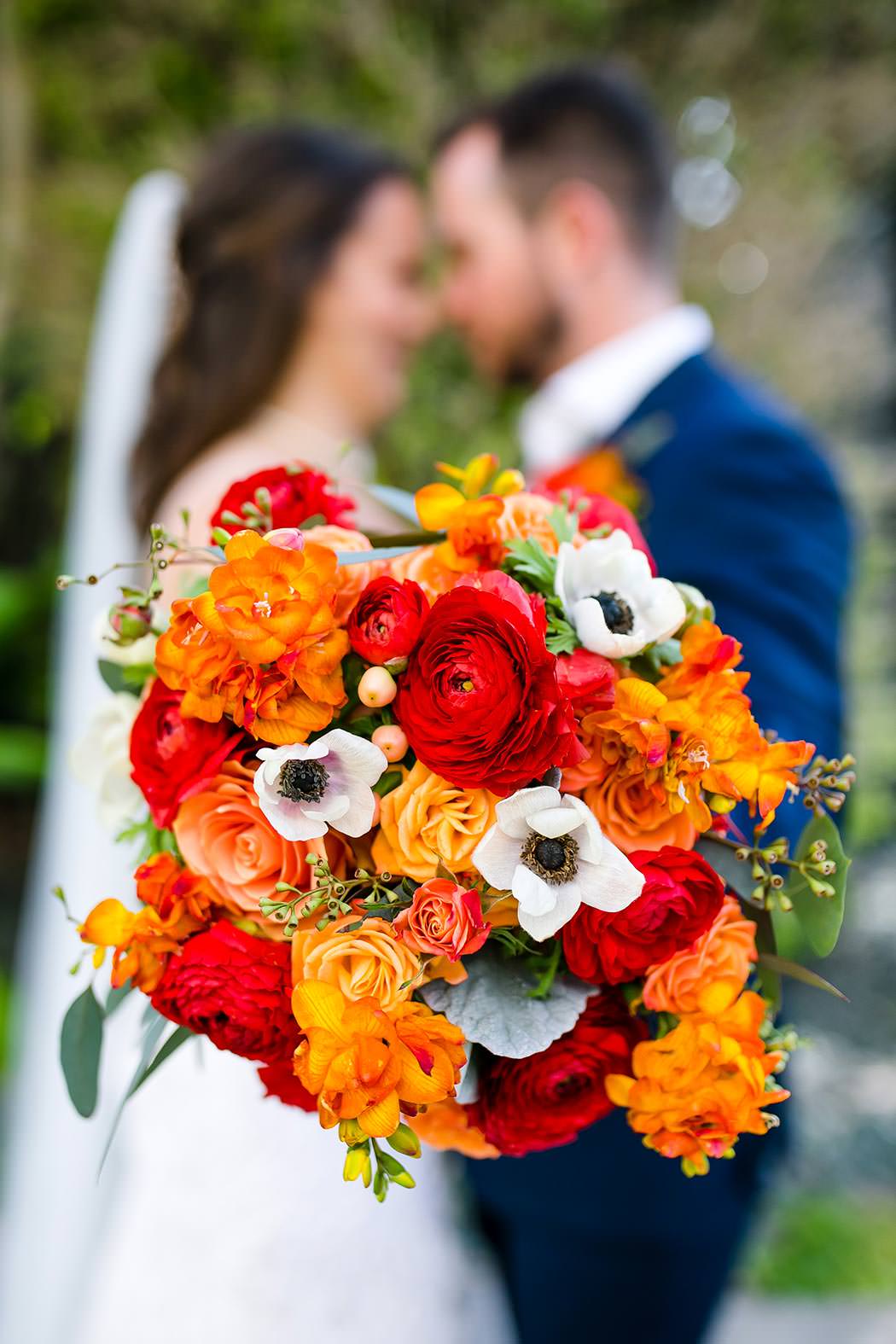 modern jewish wedding bridal portrait with red and orange bouquet