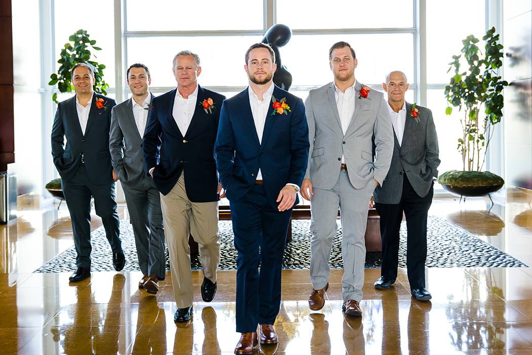 unique wedding photograph with groomsmen walking towards camera