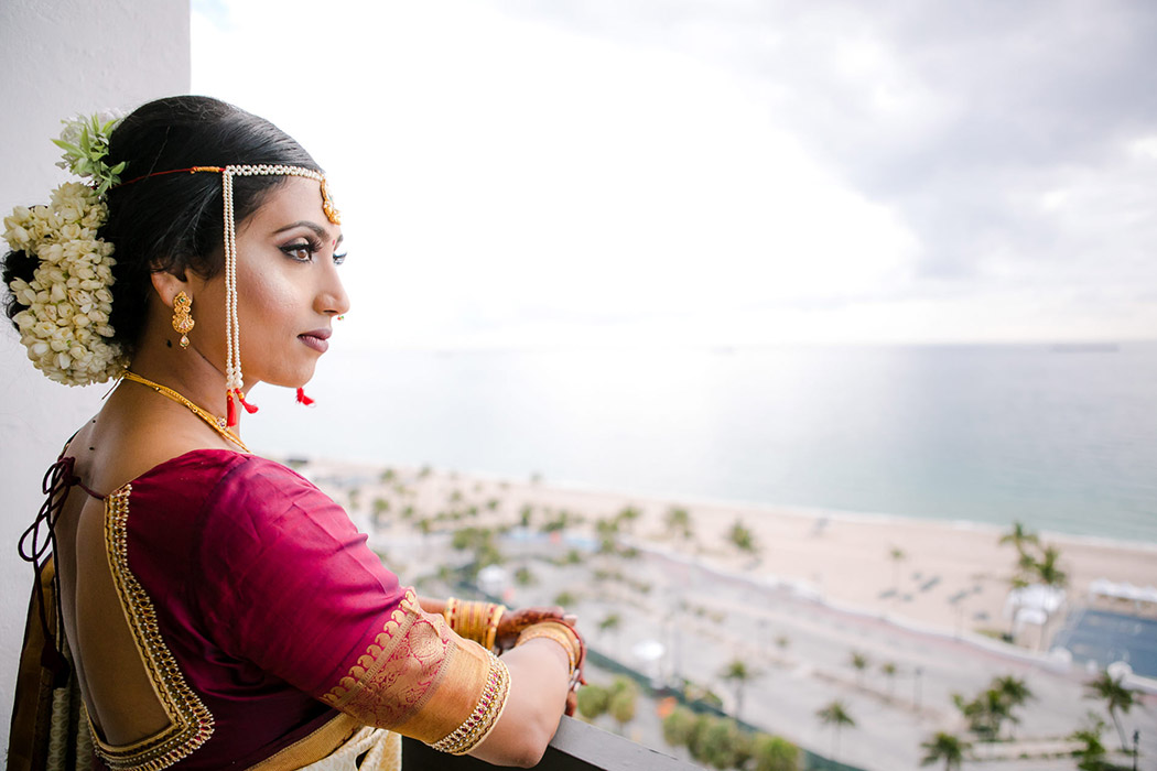 indian bride wearing gold and red sari on her south florida wedding day at bahia mar fort lauderdale