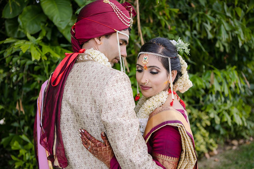 indian bride and groom pose for wedding pictures at bahia mar fort lauderdale