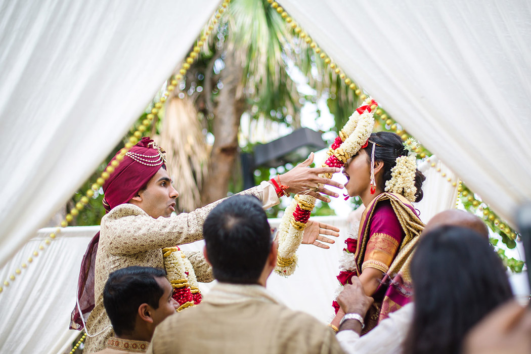 indian bride and groom photographed during the Jaimala ceremony exchange in south florida