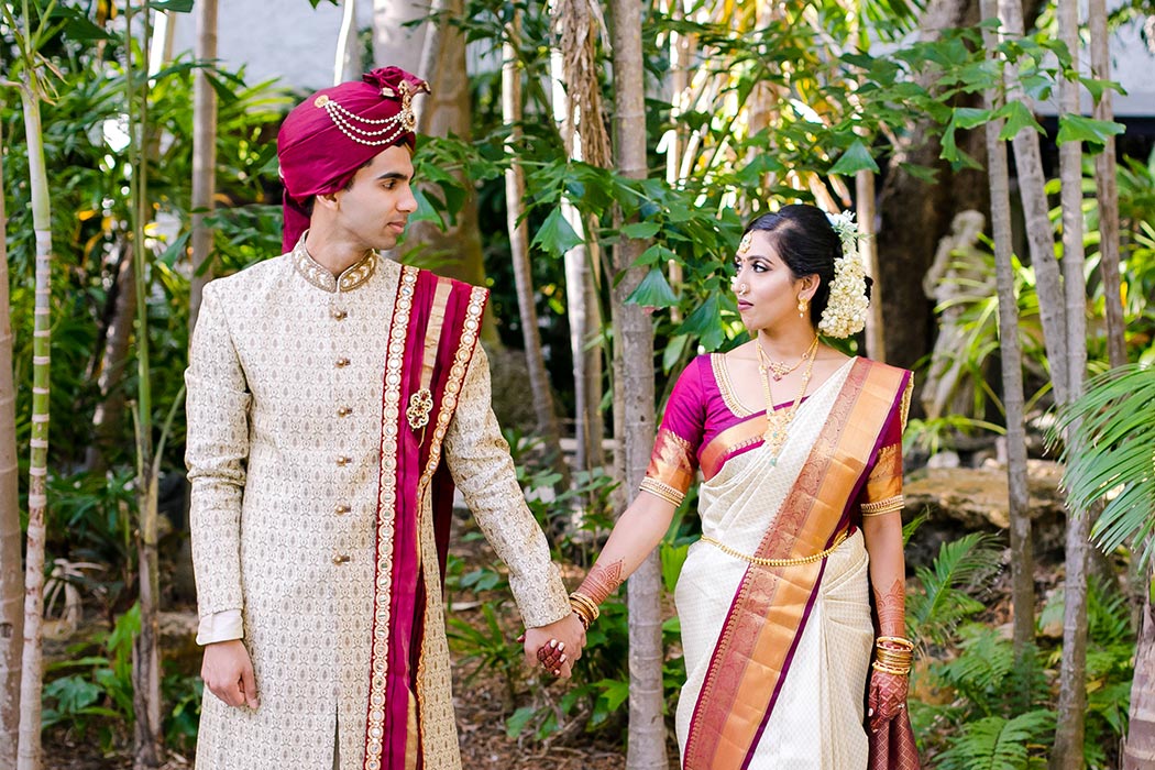 indian bride and groom in traditional gold and red wedding outfit at bahia mar fort lauderdale