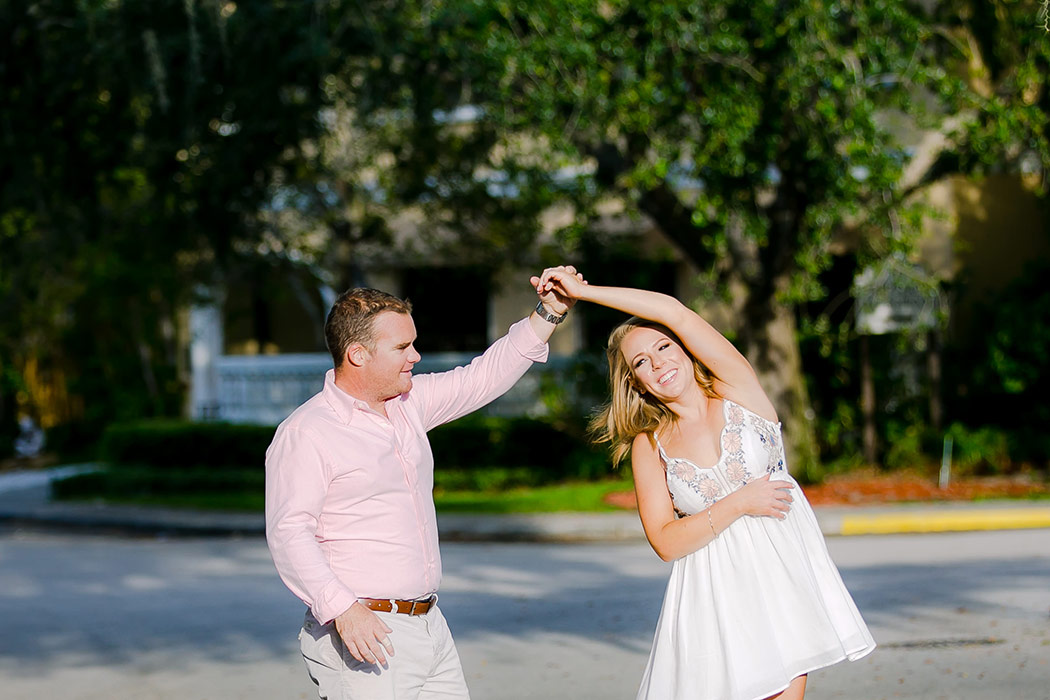 couple practice their first wedding dance during their engagement photoshoot on las olas boulevard