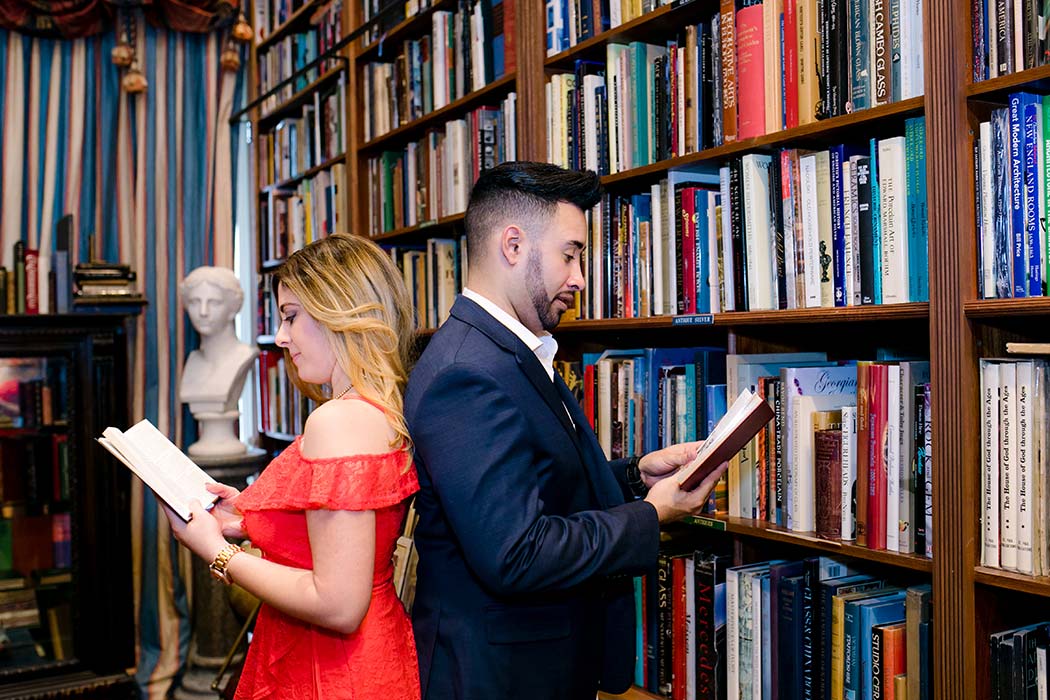 cute posing idea for a couple having their engagement session in a book store | fort lauderdale wedding photographer