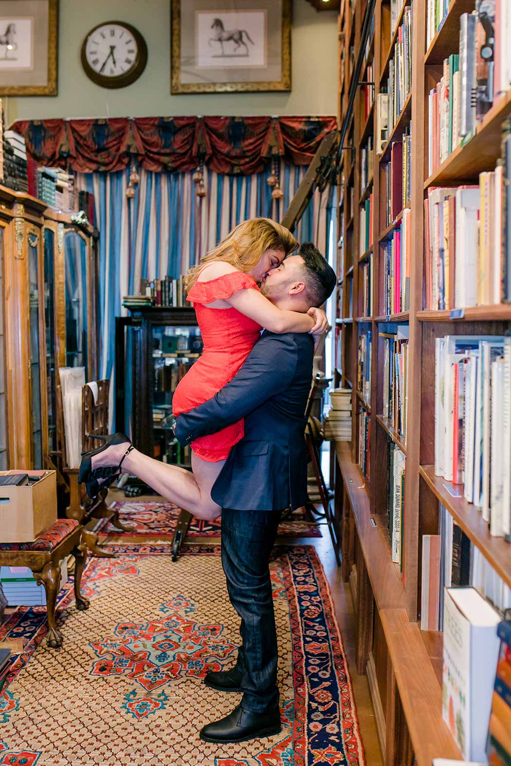 couple embrace for a flirty engagement session in old florida book shop
