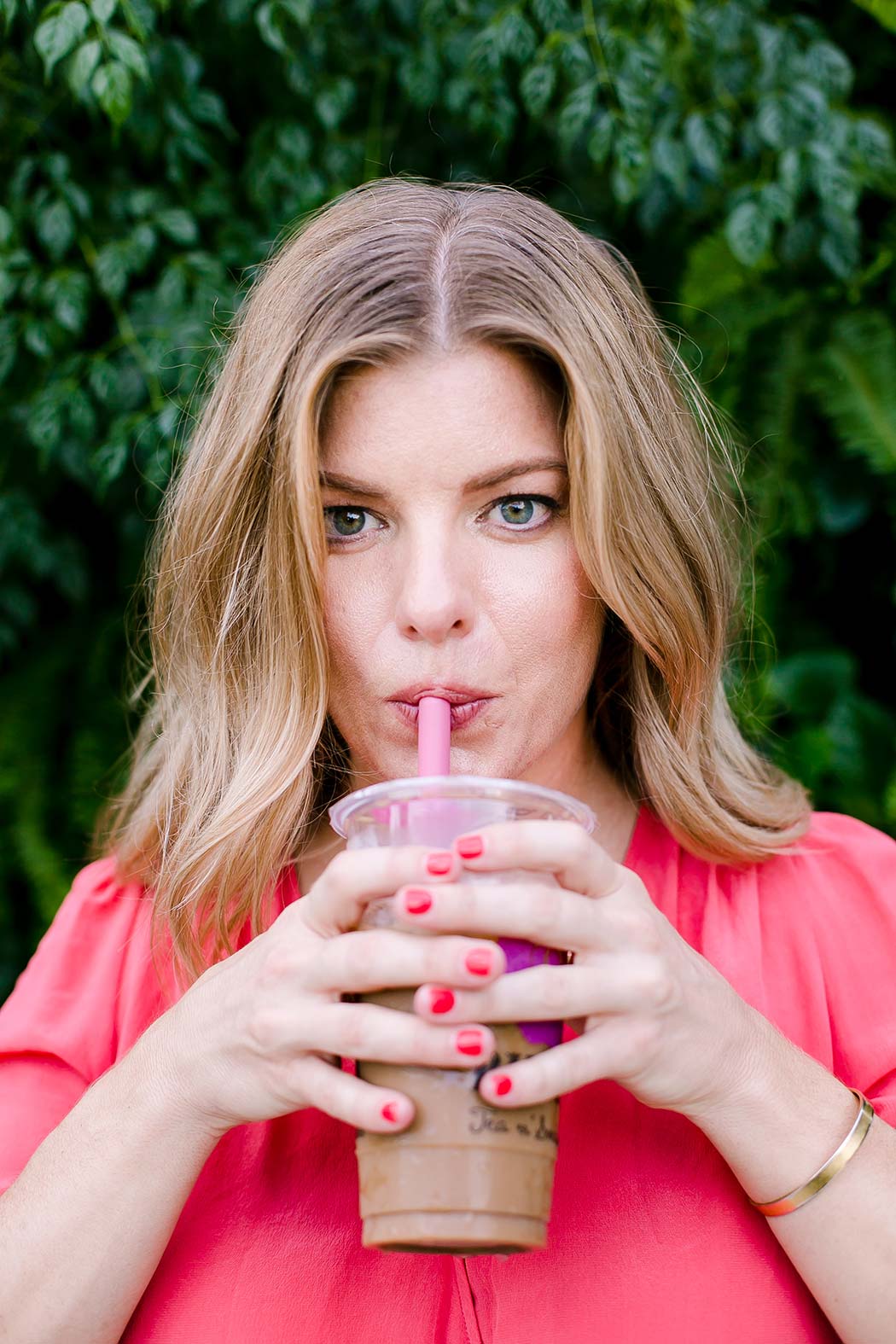 girl posing with iced coffee for a lifestyle photoshoot in wynwood yard miami