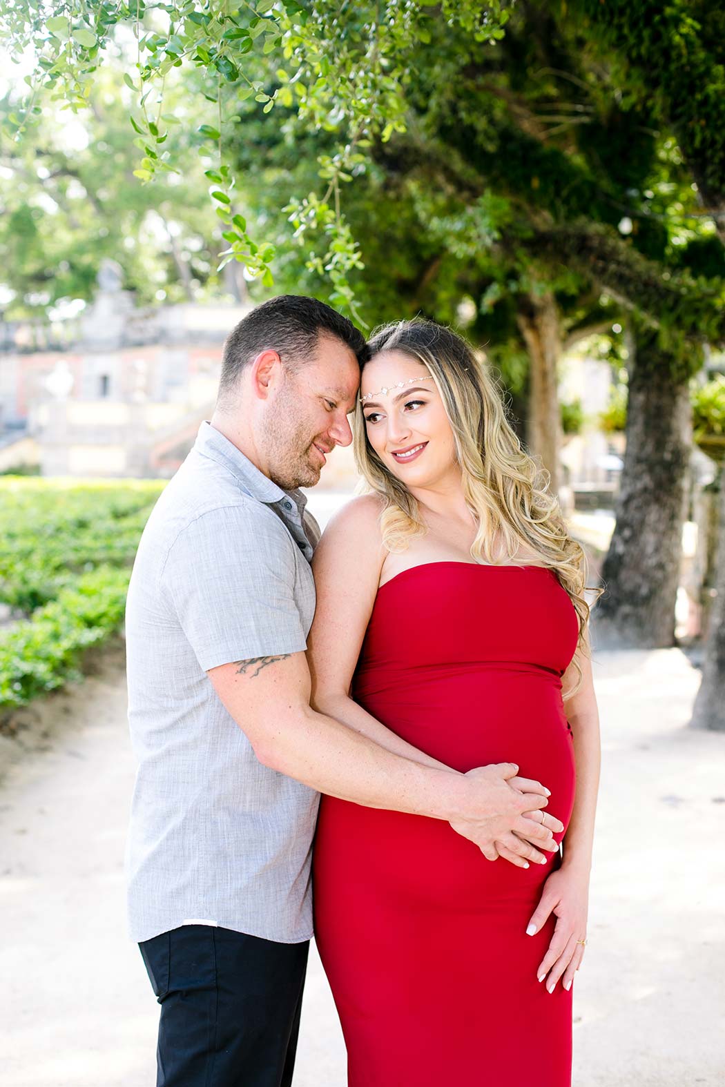 elegant maternity photoshoot at vizcaya museum miami | long red maternity dresses