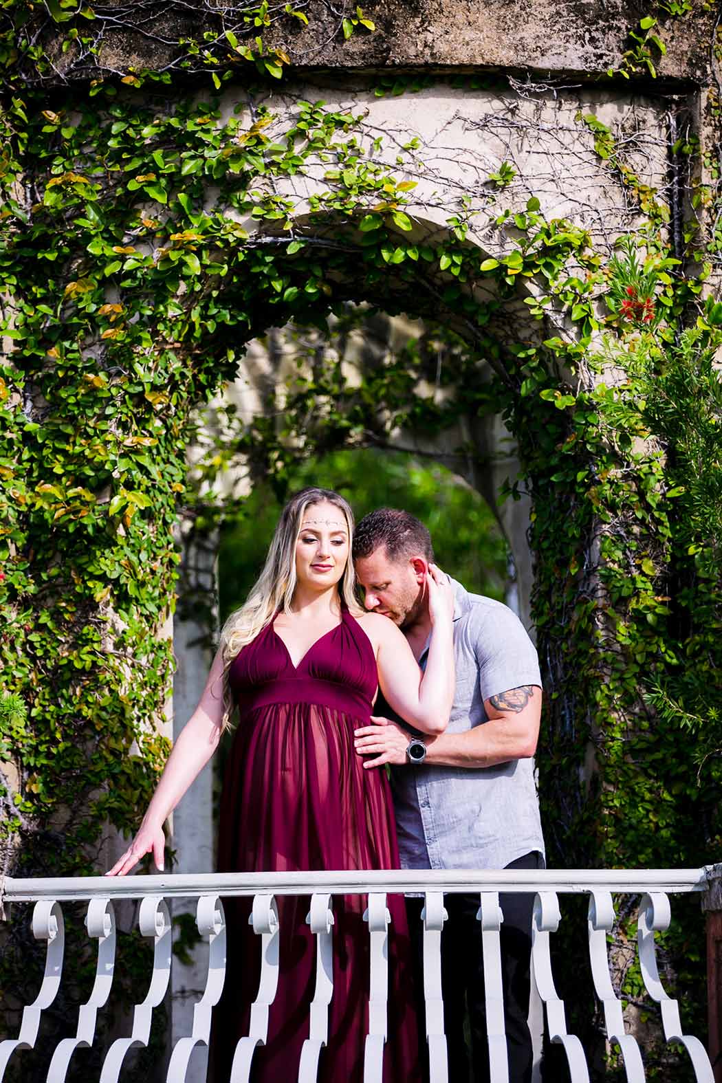 husband and wife elegant maternity session at vizcaya museum | long red maternity dress