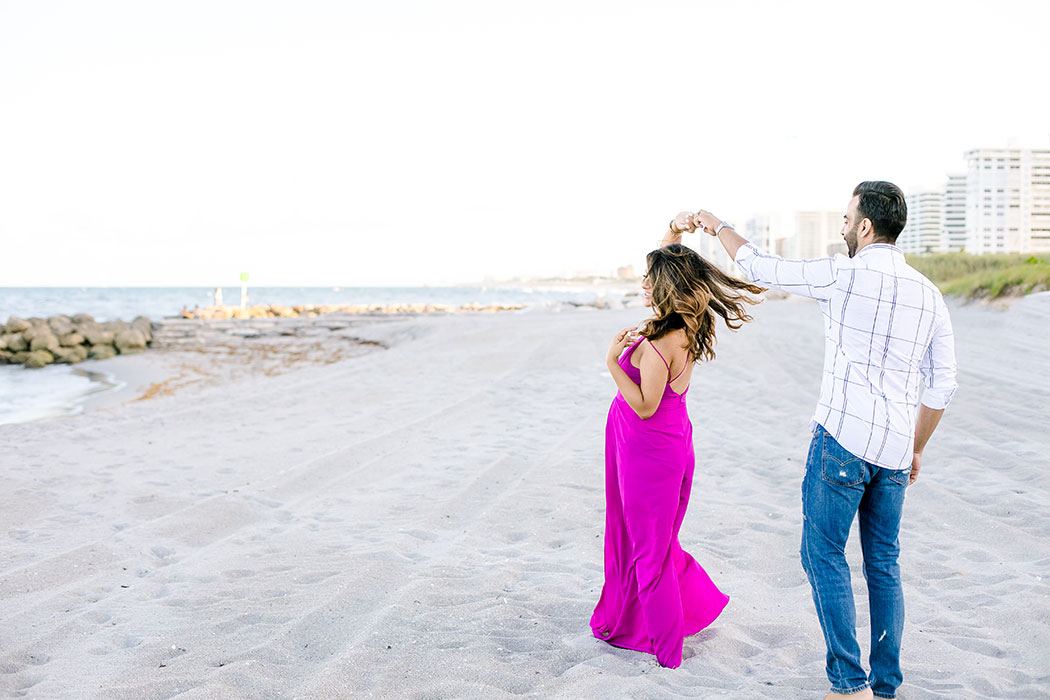 maternity photoshoot in fort lauderdale on beach | dancing couple on beach | pink maternity dress