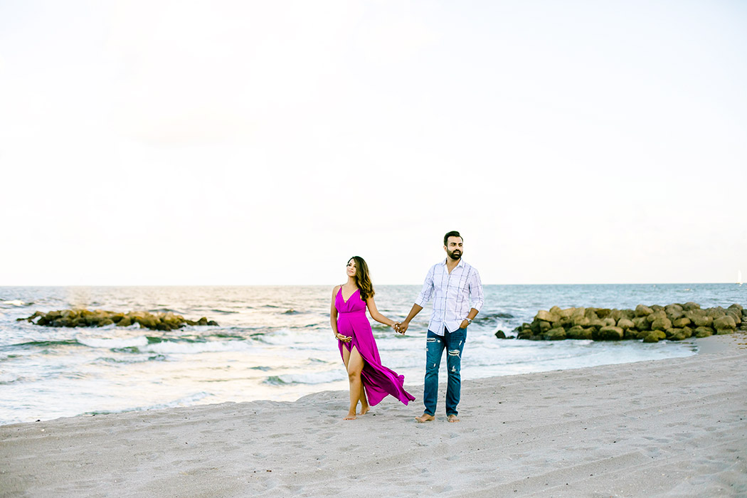 couple walk on fort lauderdale beach during maternity photoshoot | pink maternity dress