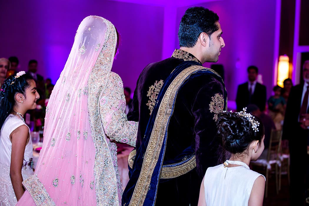 indian bride and groom enter their wedding reception at bonaventure resort and spa