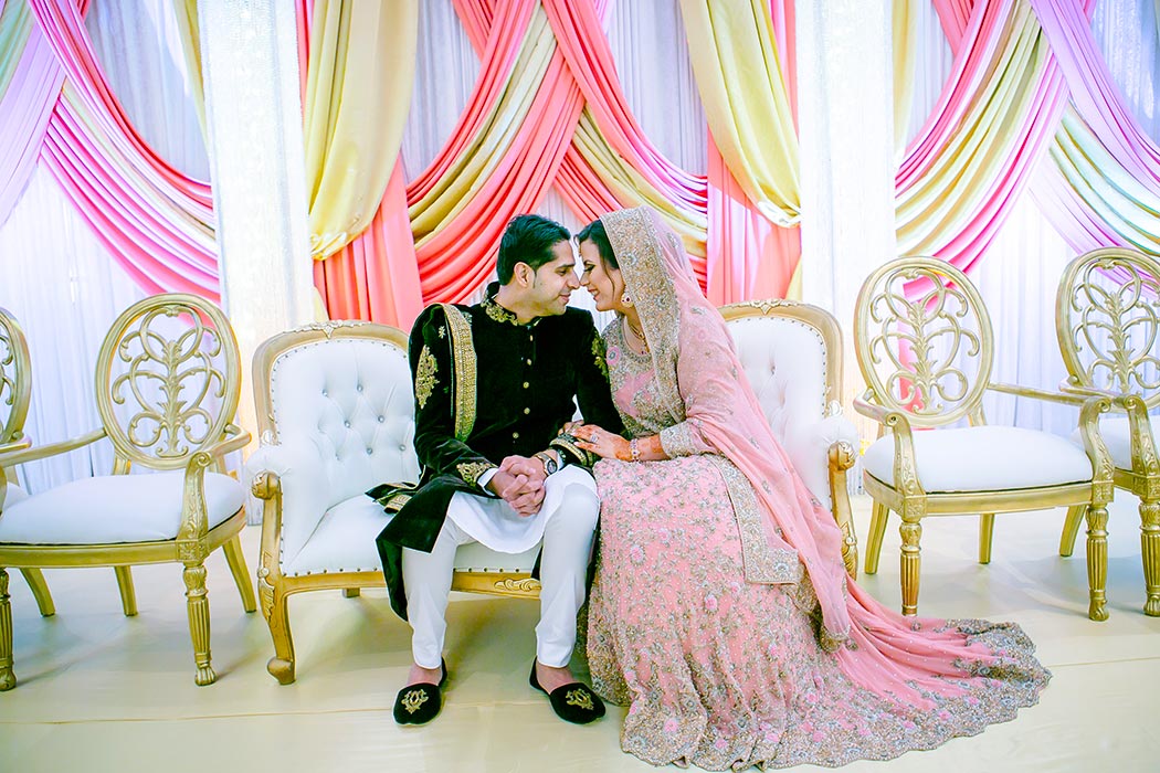 indian bride and groom posing on their indian wedding reception stage decor | fort lauderdale indian wedding photographer