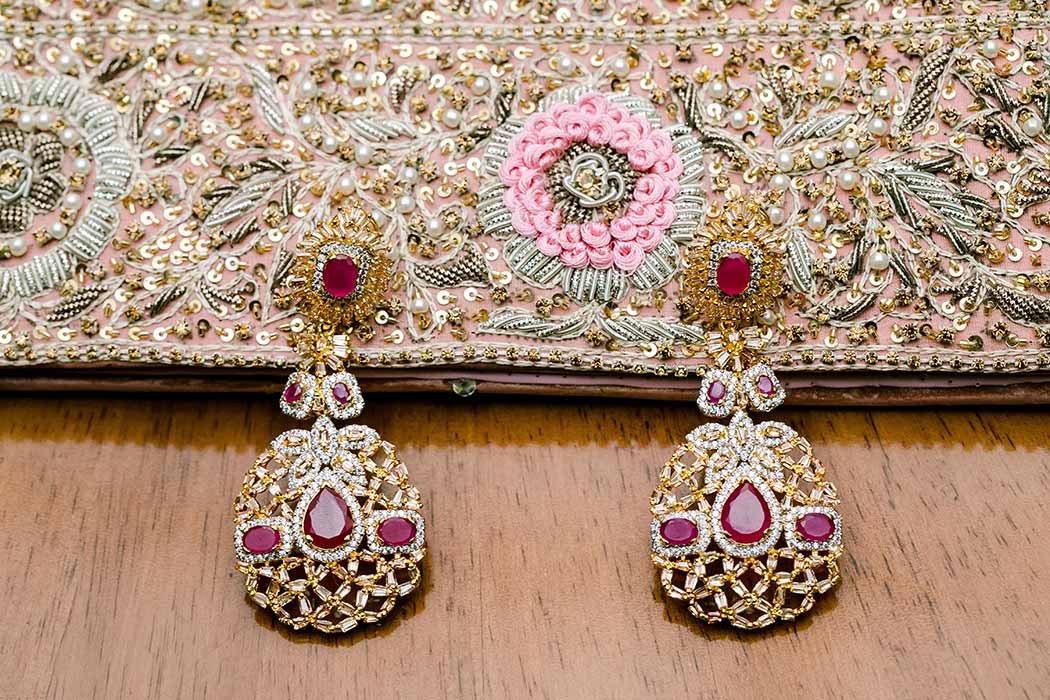 beautiful gold and red stone drop earrings and beaded bag for indian wedding | south florida indian wedding photographer