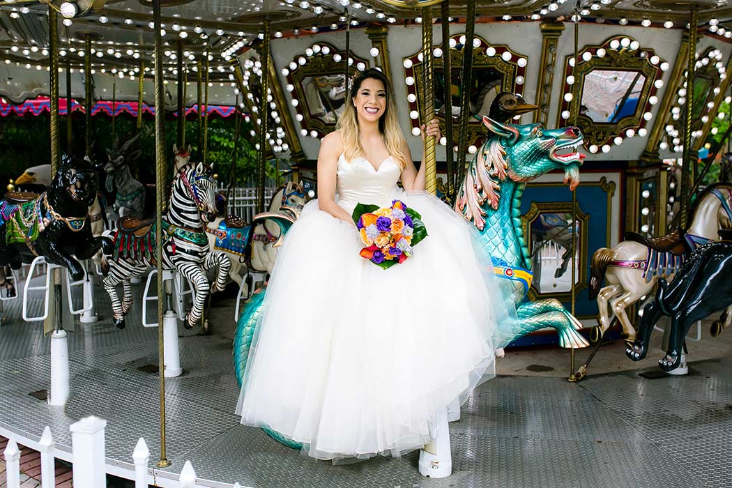 bride sits on fairground carousel for wedding photographs | palm beach zoo wedding styled photoshoot