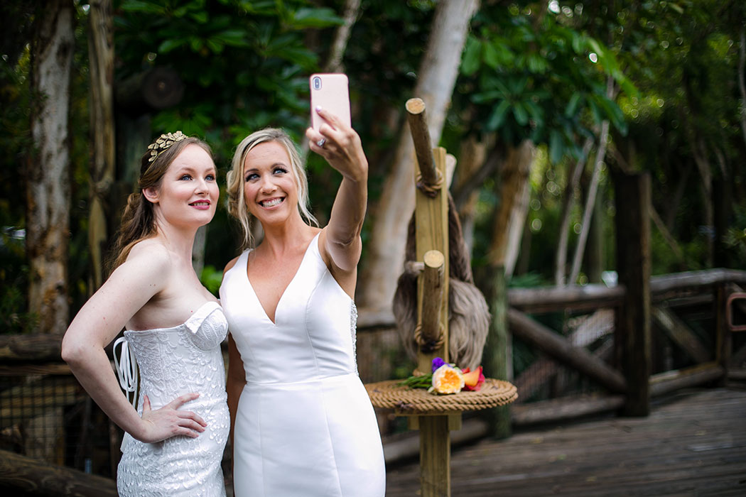 fun photographs at palm beach zoo wedding | brides taking selfies