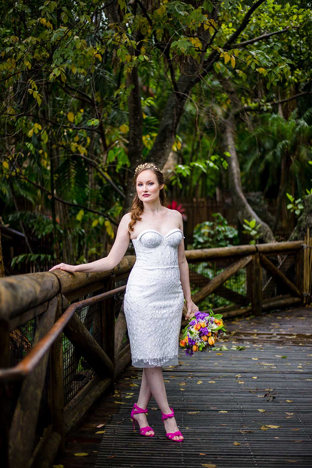 bride in modern short wedding dress and hot pink wedding shoes | purple and orange wedding bouquet at palm beach zoo wedding