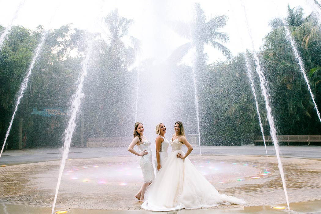 brides having fun in a water fountain during a wedding styled photoshoot in south florida