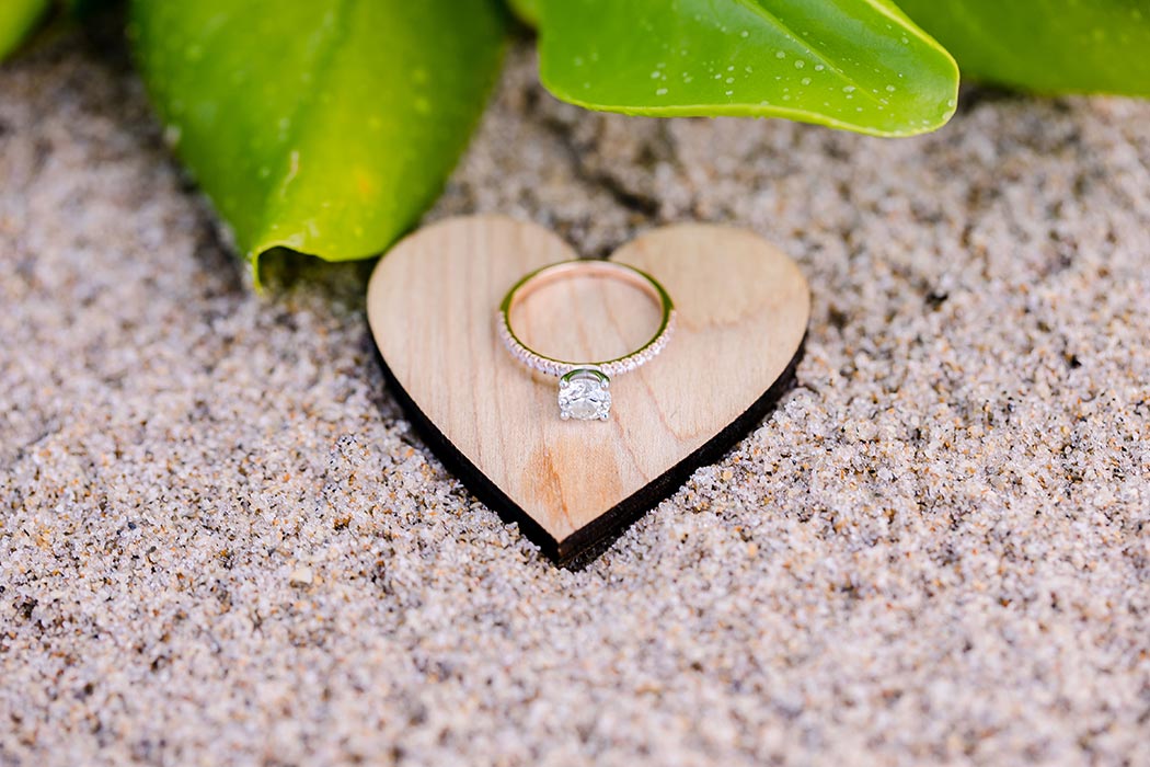 rose gold diamond engagement ring on wooden heart | natural beach engagement photography fort lauderdale