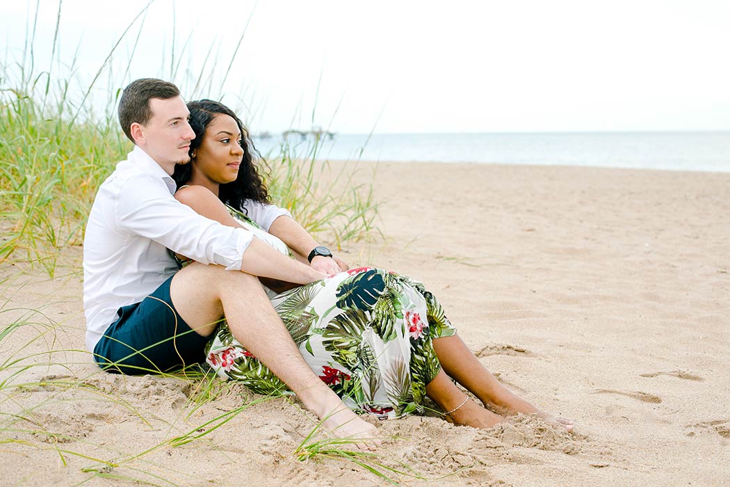 sitting pose on beach during engagement photography session | natural beach engagement photo ideas