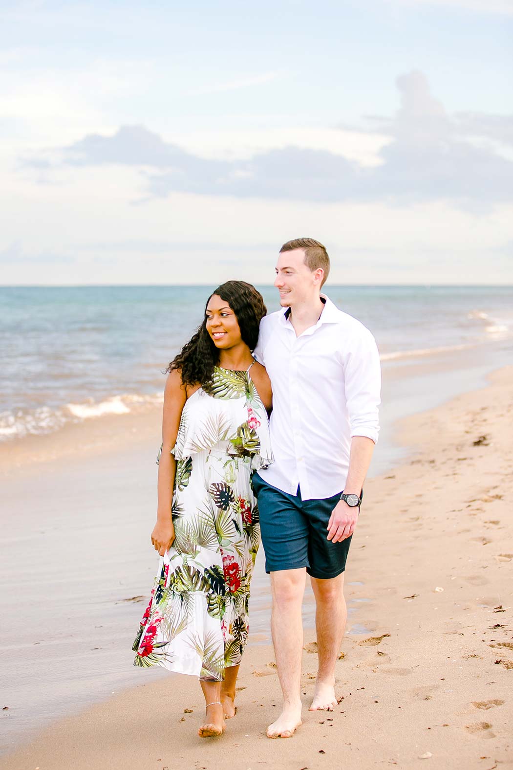 gorgeous mixed race couple pose on beach during engagement session at pompano beach south florida